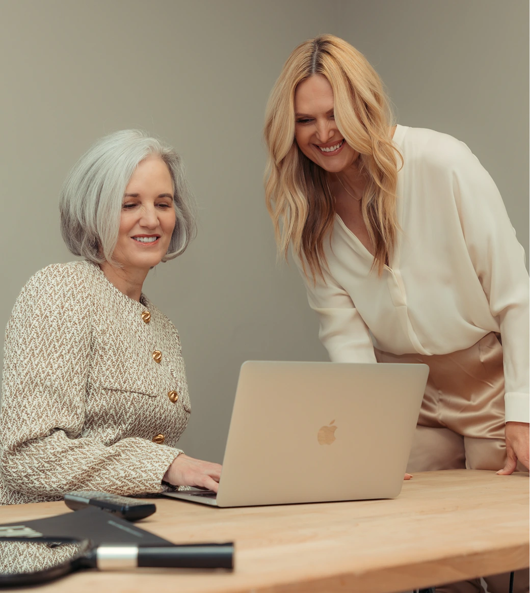 Two LuxeSkin Med Spa team members reviewing a client plan on a laptop